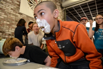 Students having fun in pie eating contest