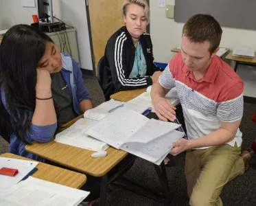 Teacher assisting students in class