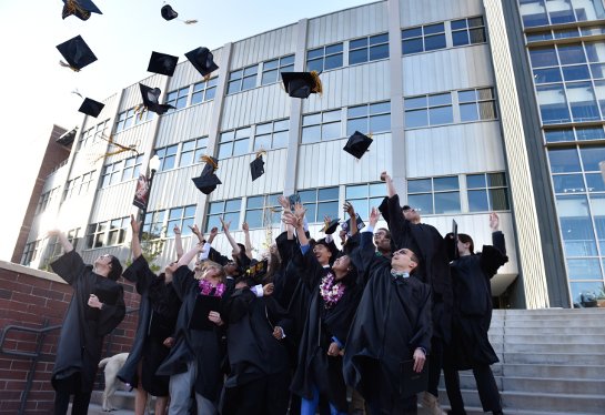 Graduates throwing their caps