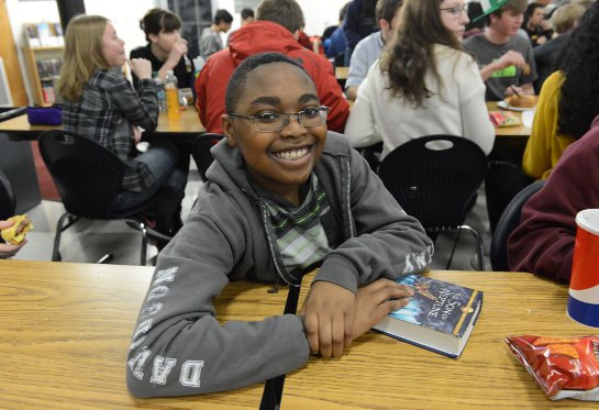 Student smiling in lunchroom