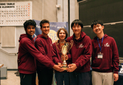Students holding a trophy