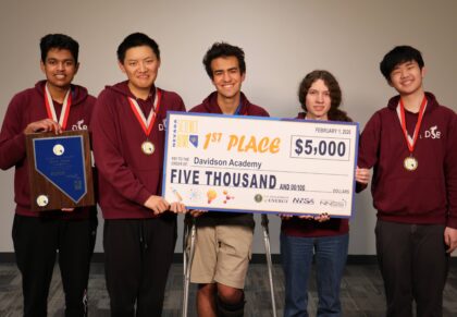 Team holding check for $5,000