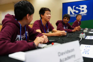 middle school team competing at a table in a ballroom